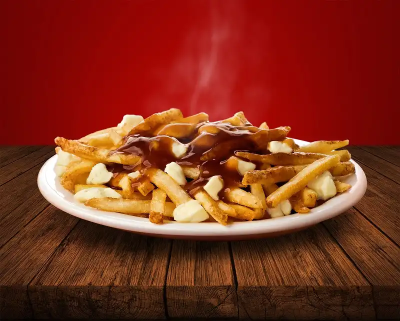 Wendy's Poutine - Building on its iconic fries, cut from whole potatoes, cooked skin-on, served hot and crispy with a sprinkle of sea salt, Wendy's poutine adds fresh Canadian cheese curds (a poutine must!) and is covered in the brand's rich poutine sauce. The delicious marriage of flavours melts together to create a truly Canadian favourite. (CNW Group/Wendy's Restaurants of Canada)