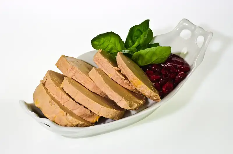 Sliced foie gras with cumberland sauce and basil leaves