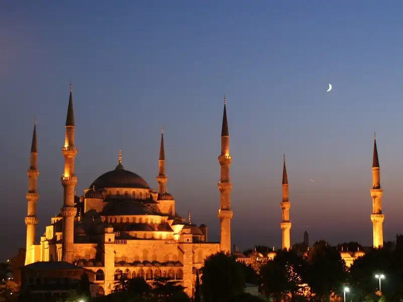 A crescent moon rises over the famous Blue Mosque in Istanbul, Turkey.