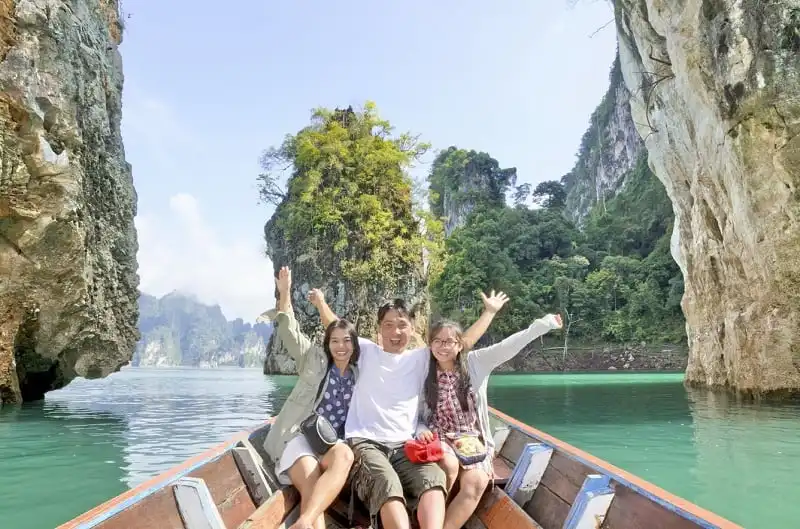 Happy family boat trip on summer vacation in Ratchaprapha Dam, Khao Sok National Park, Surat Thani Province, Thailand ( Guilin of Thailand )