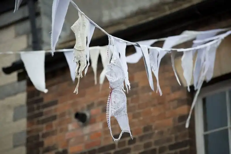 Part of the controversial bra and suspender decorations hanging in Langport, Somerset, England. Unusual Christmas decorations have divided a town after a council hung up bras and suspenders as part of a festive display. The frilly underwear bunting has offended some residents in Langport, Somerset, who reckon the "offensive" display is insulting to Christians. Appalled resident Dinga Bell said: "I have to say that I almost crashed the car in surprise. "It is the worst display I have ever seen. "It would have been far better that Langport council had hung nothing rather than this pathetic and pitiable display of abject misery. See SWNS story SWBRA: