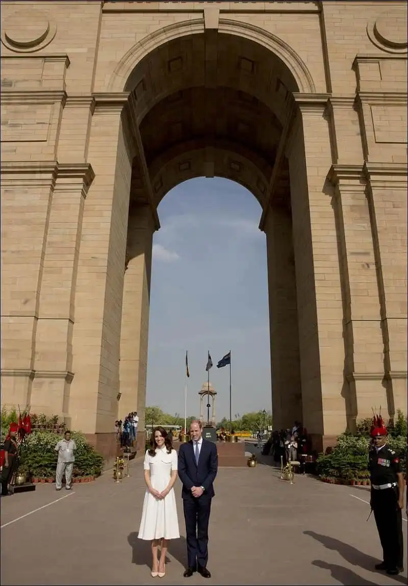 Britain's Prince William, along with his wife Kate, the Duchess of Cambridge pose for the media after paying their tributes at the India Gate war memorial, in the memory of the soldiers from Indian regiments who served in World War I, in New Delhi, India, Monday, April 11, 2016. (Manish Swarup/Pool Photo via AP)