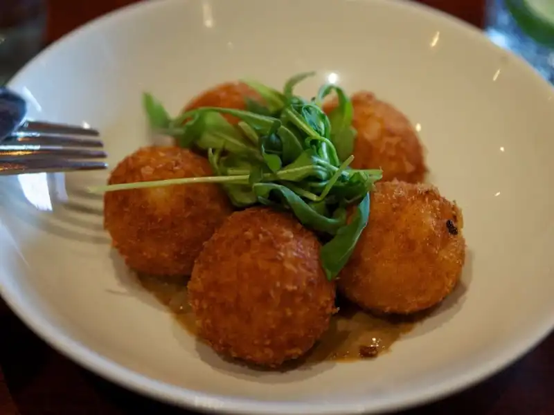 Lớp vỏ bên ngoài của arancini được nấu bằng gạo Ý trộn với bột nghệ. Lớp nhân bên trong thường được nhồi với nước xốt cà chua, phô mai mozzarella, thịt hầm ragu và đậu Hà Lan. Những viên cơm được vo tròn, lăn vào lớp lòng đỏ trứng gà, sau đó bọc thêm một lớp áo từ bột mì và được chiên trong dầu nóng, đây là một món đường phố rất nổi tiếng ở Italy.