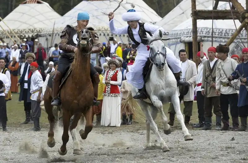 In this photo taken on Sunday, Sept. 4, 2016, participants take part in a horse-riding competition during the second World Nomad Games at Issyk Kul lake in Cholpon-Ata, Kyrgyzstan. The Games, which opened on Saturday on a picturesque mountain plain in eastern Kyrgyzstan, bring together athletes from 40 countries including Russia and the United States where nomadic traditions are strong. (AP Photo/Vladimir Voronin)