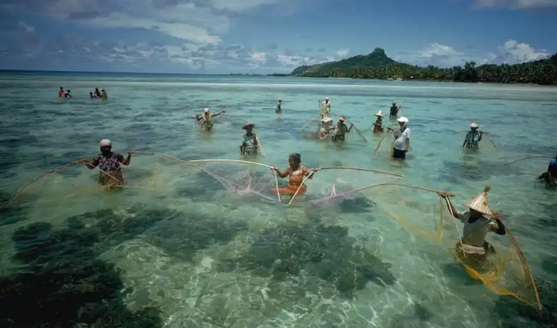 ca. 1970-1986 --- Islanders Fishing in Truk Lagoon --- Image by © Jack Fields/CORBIS