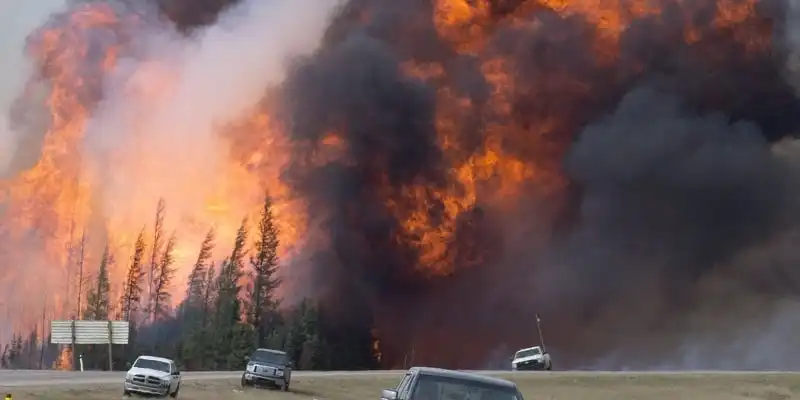 A giant fireball is seen as a wild fire rips through the forest 16 km south of Fort McMurray, Alberta on highway 63 Saturday, May 7, 2016. THE CANADIAN PRESS/Jonathan Hayward