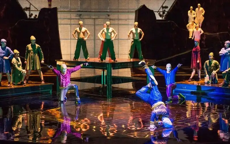 For the first time in any Cirque du Soleil show, a B-Boy trio is featured in their own electrifying act. B-Boying is a physically demanding form of dance, in which performers execute acrobatic tricks and moves, including flips and spins, to music.