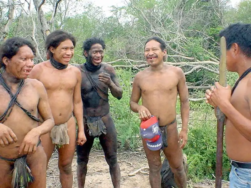 ALTO CHACO, PARAGUAY: Part of a group of 18 families of forest dwellers belonging to an ethnic group known as "Ayoreos totobiegosode silvicolas" approach 03 March 2004 other members of their tribe who live already integrated to modern society, in Chaidi, high Paraguayan Chaco, 520 km north of the capital Asuncion. The ayoreos are truly forest men and women who seldom have contact with modern civilization and in ocassions have reportedly behaved aggressively. AFP PHOTO STR-ABC COLOR MAXIMUM QUALITY AVAILABLE (Photo credit should read STR/AFP/Getty Images)